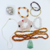 A collection of necklaces including two amber, pearl and rose quartz, Chinese quartz pendant, etc