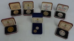 Seven Pobjoy Mint proof silver and proof coins, consisting of crowns and a £1 coin etc
