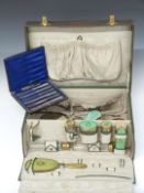Green leather travelling vanity case with fitted interior and bottles, together with two guilloché