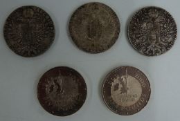 Three Maria Theresa coins and two Millennium £5 crowns