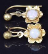 A pair of yellow metal earrings set with an opal to each