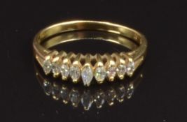 An 18ct gold ring set with marquise cut diamonds, size M, 2.2g