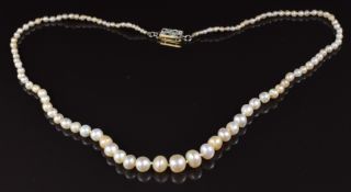A single strand of 103 natural pearls, the 18ct gold clasp set with diamonds and emeralds, with