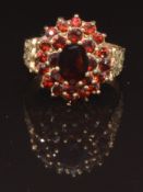 A 9ct gold ring set with a cluster of garnets, size O, 4.1g