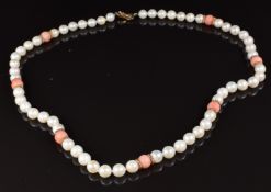A single strand cultured pearl and coral necklace with a 9ct gold clasp and dividers, in Mikimoto