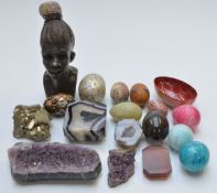 A section of amethyst and agate geodes, carved stone African head, eggs, etc