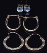 Two pairs of 9ct gold earrings and a pair of 9ct gold earrings set with topaz, 1.7g