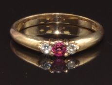 A 9ct gold ring set with a round cut ruby and two round cut diamonds, size N, 2.3g