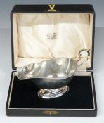 Cased George V hallmarked silver sauce boat, Birmingham 1930, maker Charles S Green & Co Ltd, length