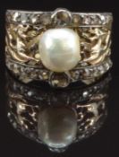 A 19thC ring of pierced phoenix design, set with a natural pearl and rose cut diamonds, size O, 6.