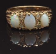 A 9ct gold ring set with three white opal cabochons, size P, 3.5g