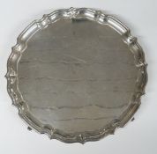 George VI hallmarked silver salver with shaped edge and raised on four feet, Birmingham 1938,