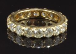 A 14k gold eternity ring set with 18 round cut diamonds, total diamond weight approximately 3.6ct,
