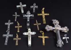 A collection of cross and crucifix pendants including silver, mother of pearl and two 9ct gold, 2.