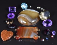 A collection of loose stones including zircon, agate, amethyst, garnet, etc
