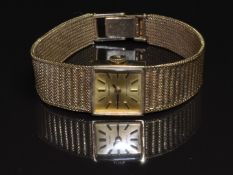 Tissot Stylist 9ct gold ladies wristwatch with black hands, two-tone baton markers, gold dial and