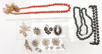 A collection of silver/ white metal filigree brooches, coral necklace, hardstone necklaces and two