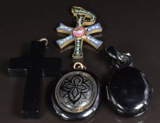 Victorian jet locket opening to reveal a portrait and plaited hair, a Victorian jet pendant, a cross