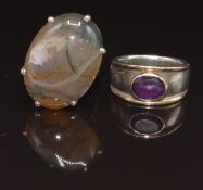 A silver ring set with an agate cabochon and a silver ring set with an amethyst