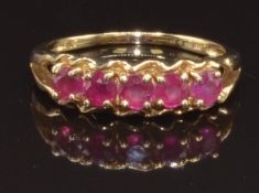 A 9ct gold ring set with five round cut rubies, size N, 2.4g