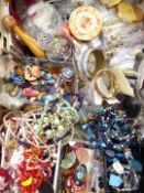 A collection of costume jewellery including faux pearls, mother of pearl buckles, Stratton compacts.