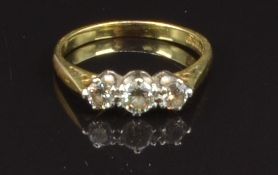 An 18ct gold ring set with three diamonds, size I, 2.1g