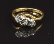 An 18ct gold ring set with three diamonds in a platinum illusion setting, size J, 2.9g