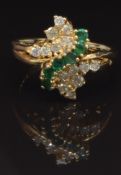 A 14k gold ring set with round cut emeralds and diamonds, size Q, 5g