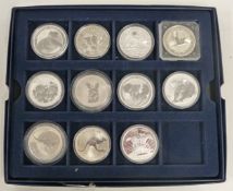 Eleven Australian silver dollars, koalas, kookaburra, kangaroo etc