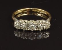 An 18ct gold ring set with five diamonds in a platinum setting, size O, 3g