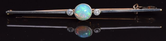 A 15ct gold brooch set with an opal cabochon and diamonds with a platinum finish, in original box,