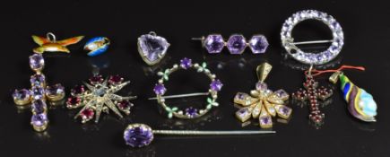 A collection of Victorian/ Edwardian pendants and brooches set with amethysts, garnets, etc