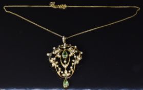 Edwardian 15ct gold pendant set with two pear cut peridots and seed pearls, on a 15ct gold chain,