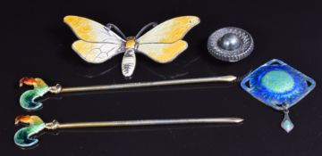 A hallmarked silver pendant set with green and blue enamel, a Victorian silver button, a silver