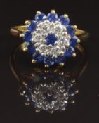 An 18ct gold ring set with diamonds and sapphires in a cluster, size M/N, 4.8g