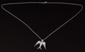 An 18ct white gold pendant in the form of a swallow set with diamonds, 4g