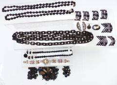 A collection of jet beads, vulcanite necklace, jet buckles, cut steel buckle, French jet buttons,