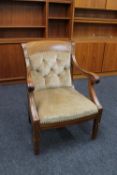 A continental mahogany buttoned dralon armchair