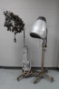 A 1930's hair salon dryer and curler machine on cast iron stand