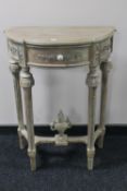 A reproduction demi lune hall table
