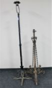 An antique cast iron standard lamp together with a cast iron oil lamp base