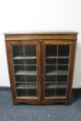 An Edwardian oak double door leaded glass door bookcase