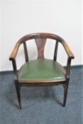 An Edwardian stained beech desk armchair with green leather seat