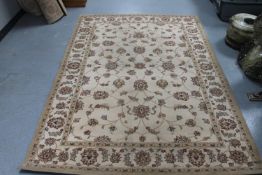 Three machine made floral rugs on beige ground