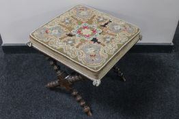 A Victorian tapestry X-frame stool on bobbin legs