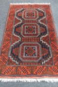 An Afghan Bokhara rug on rust ground