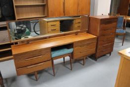 A three piece teak bedroom suite