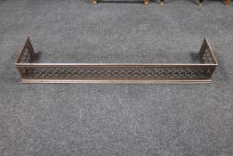 An antique chrome fire curb