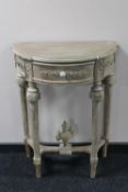 A reproduction demi lune hall table
