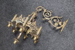 An antique brass seven candle wall sconce